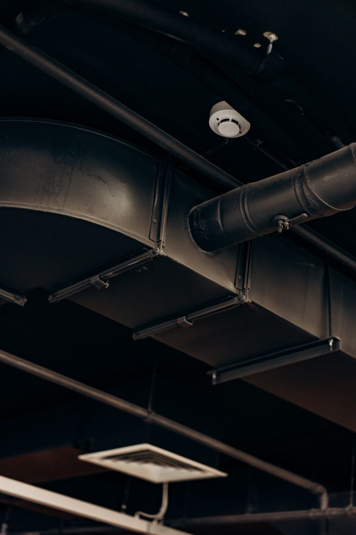 Crafting Captivating Headlines: Your awesome post title goes here Detailed view of industrial air ducts on a ceiling, showcasing modern urban design.